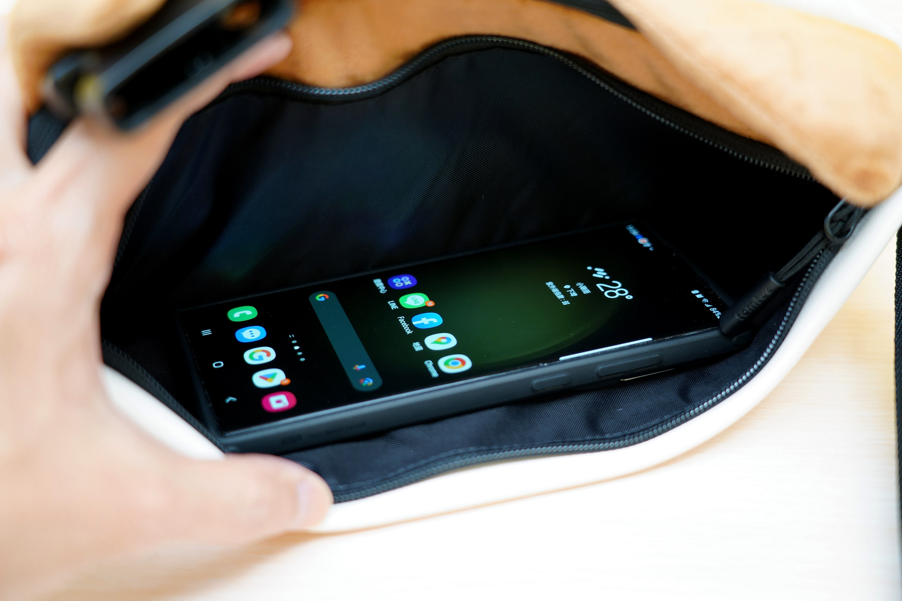 後面的拉鍊收納袋是單一無隔層的,尺寸剛好可以用來貼身放手機 image