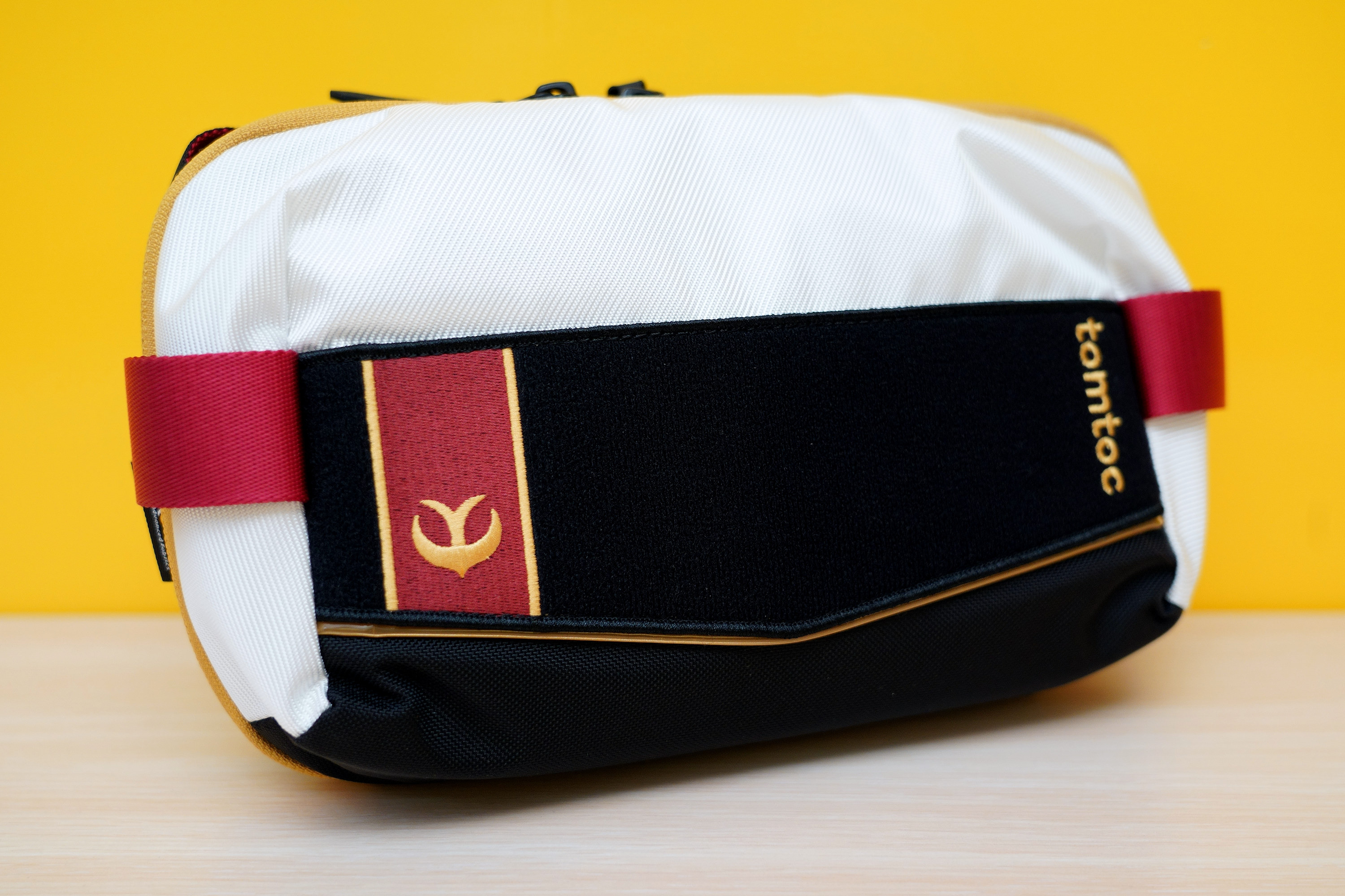 延續「王國騎士」系列防具的黑白紅配色風格,尺寸比 S 號斜肩包稍大一些,沒有背帶但有提帶 image